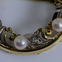 closeup of metal work, pearls, and diamonds