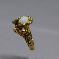 sideview of the ring showing the textured band and prongs