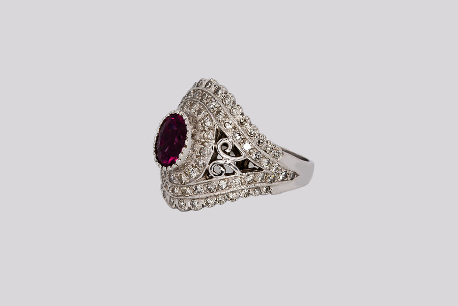 side angled view of the ring showing the filigree accent and single cit diamonds