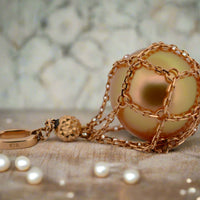 viewing a pearl in the net pendant
