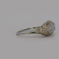 viewing the ring from the side and showing the filigree work and diamonds