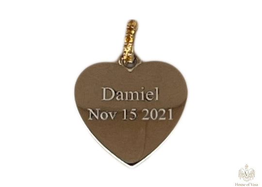 a heart shaped pendant celebrating the birth of a client's child.