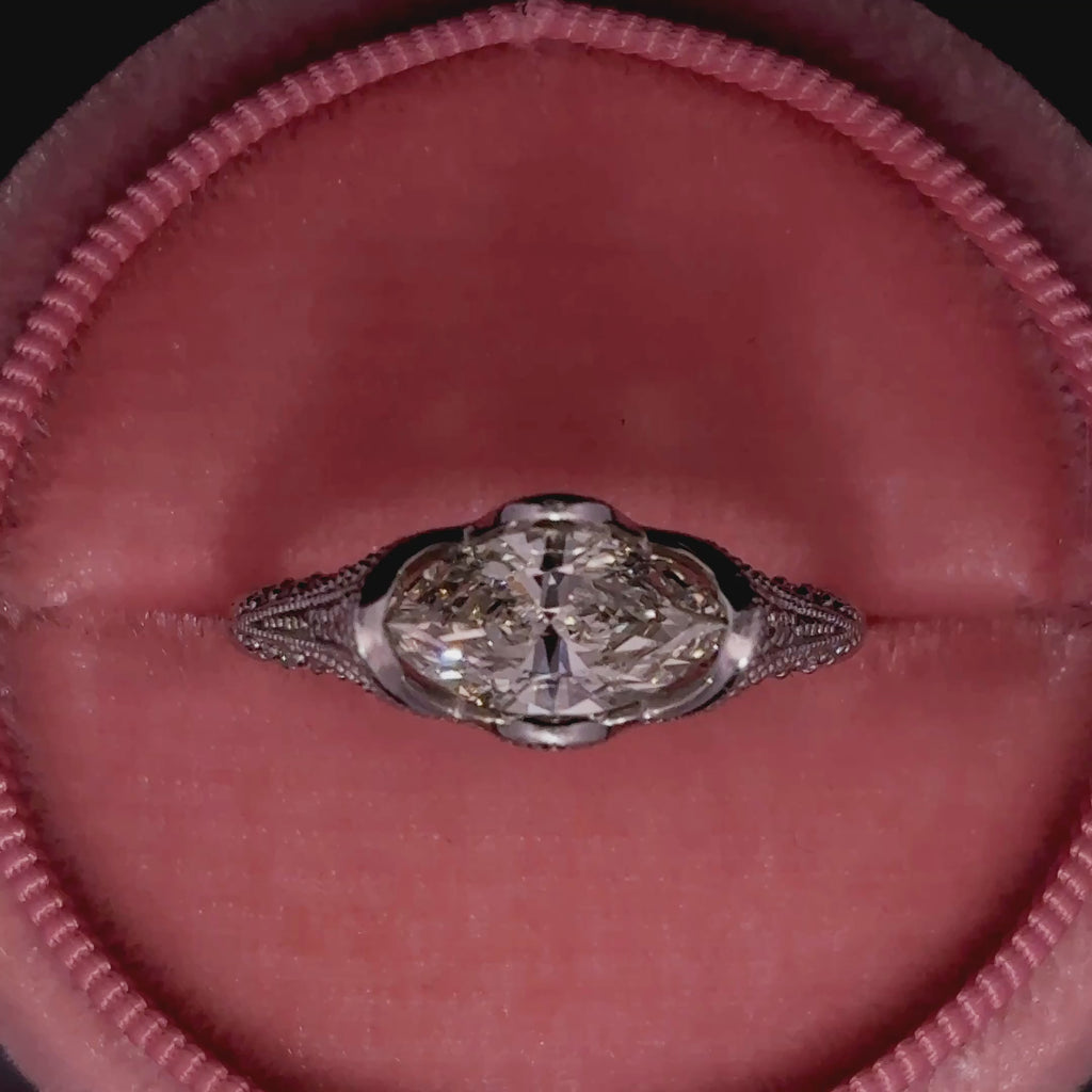 a close up video showing the marquise cut diamond in the center of the ring