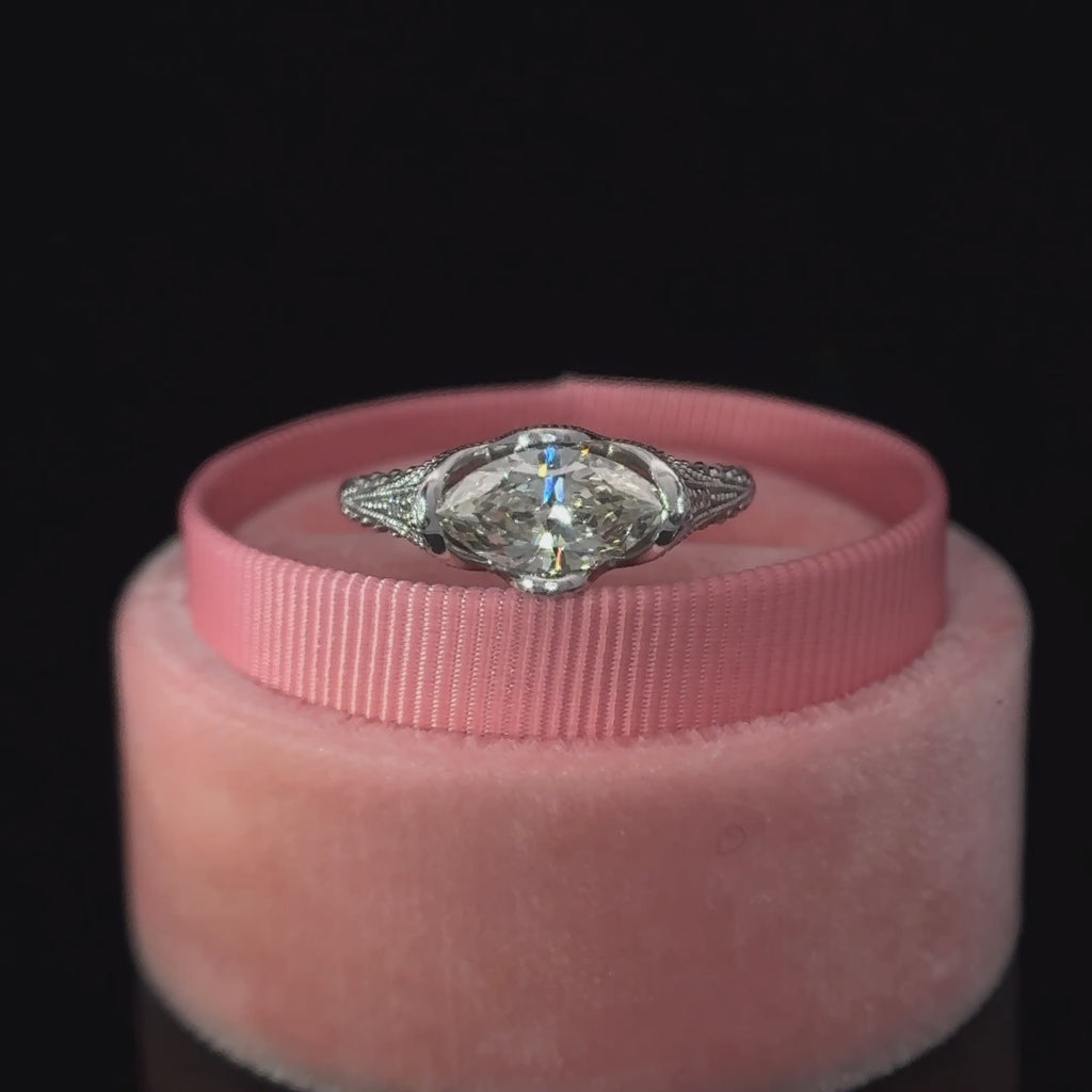 a video showing the marquise cut diamond in the center of the ring