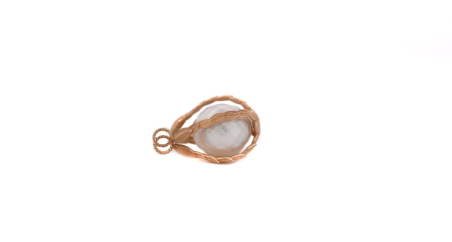 a white south sea pearl inside the pearl cage