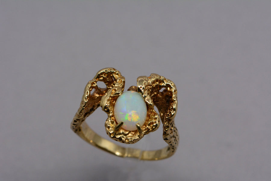top view showing the opal's play of colour and the textured ring band