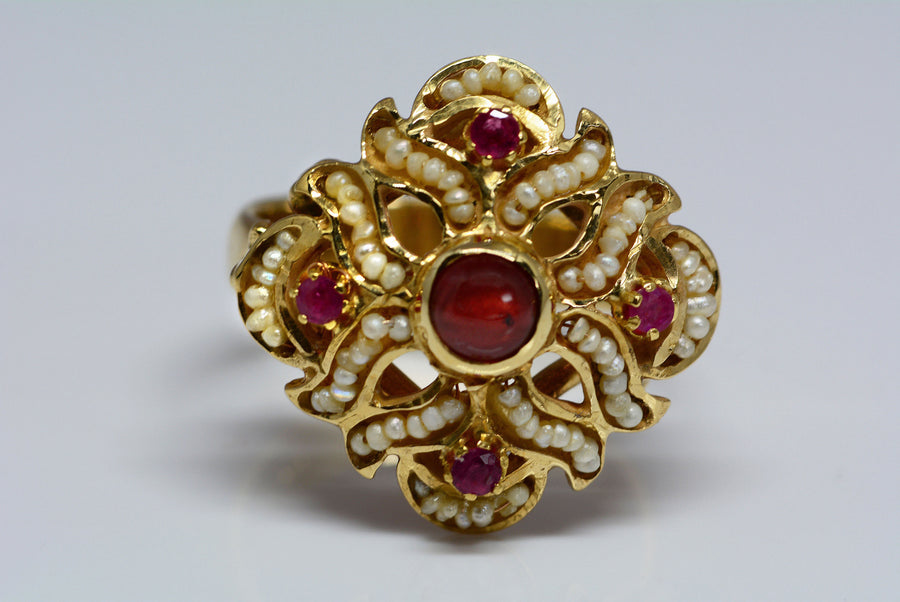 top of the ring showing the rubies, garnets, and pearls