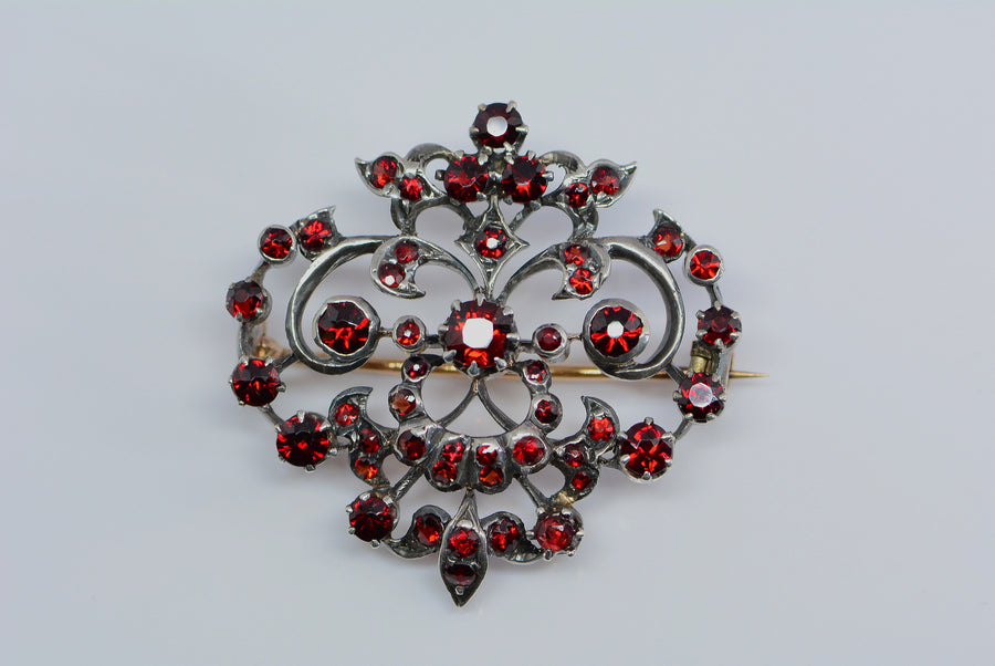 front view of the brooch showing old mine cut garnets