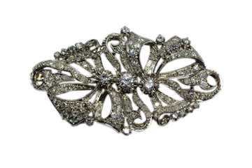 front view of the brooch with flowing ribbon/ bow motif