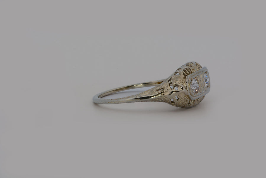 viewing the ring from the side  and showing the filigree work and diamonds